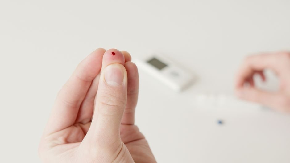 A finger blood-sugar check illustrating prediabetes in men explained through routine glucose testing