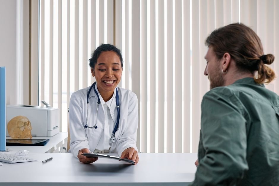 A man having a calm consultation with his doctor to get testosterone therapy explained during a checkup