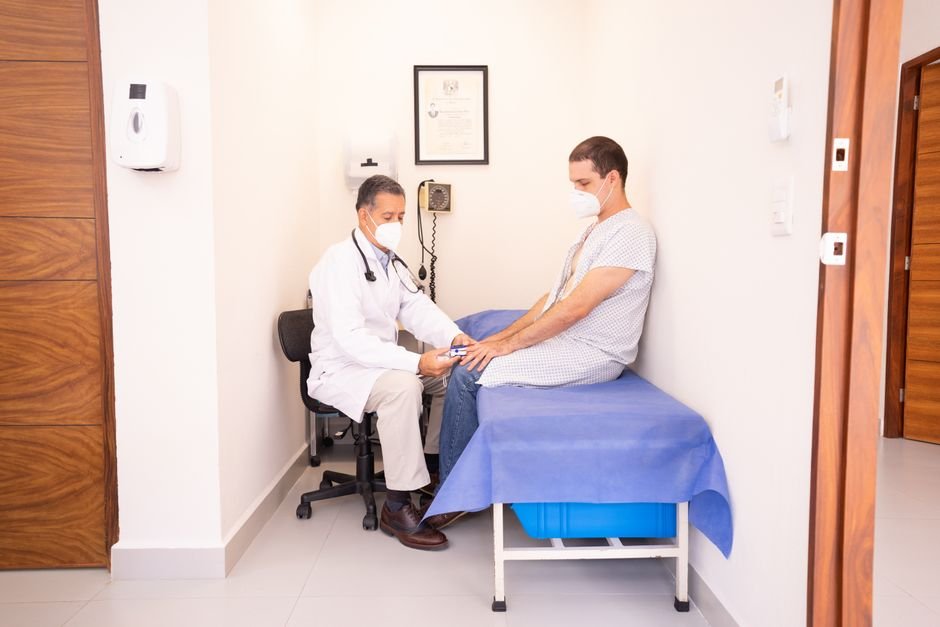 A man having his vitals checked as a doctor evaluates possible low testosterone symptoms
